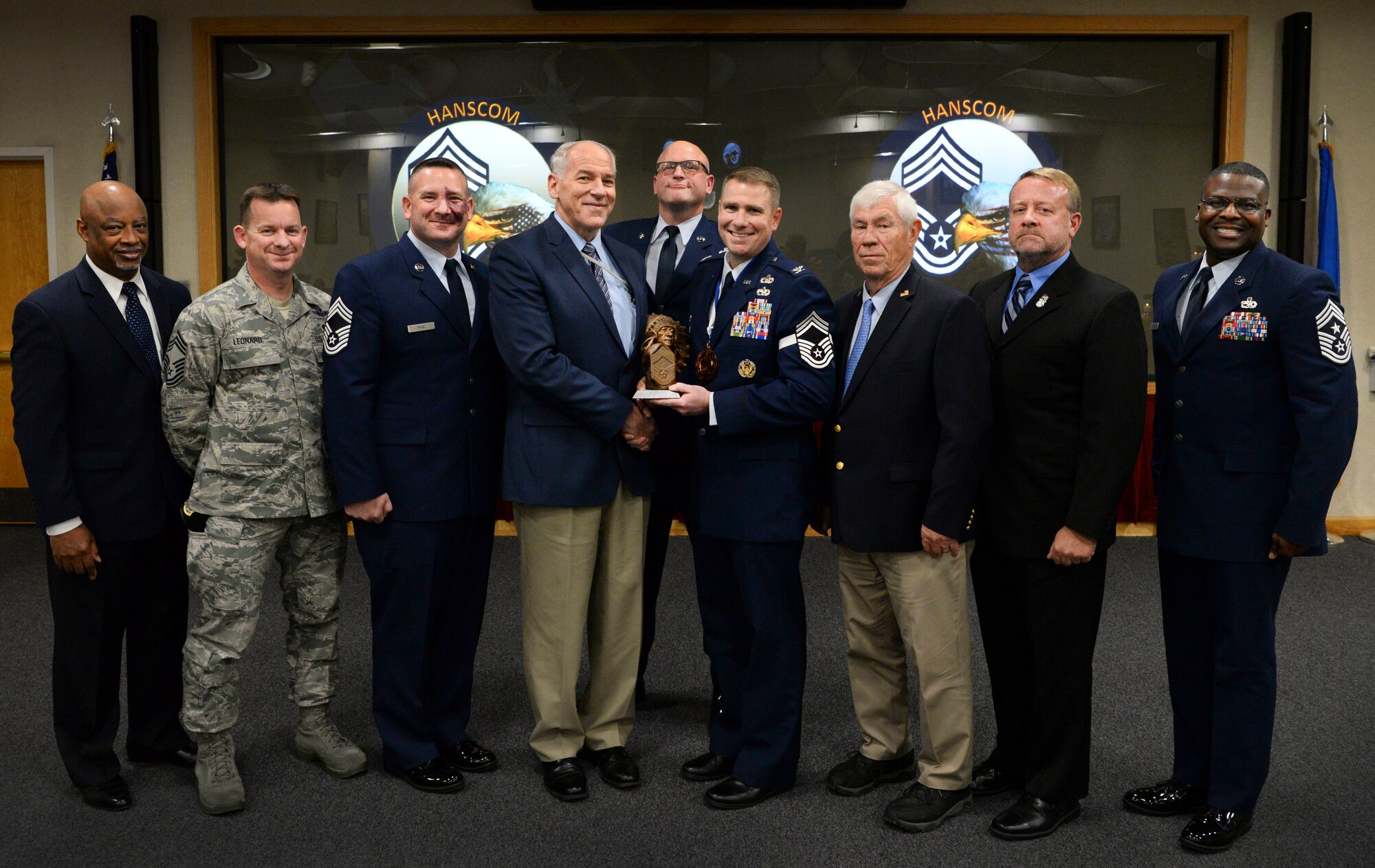 Members of the Hanscom Chief’s Group present Col. Chad Ellsworth, 66th Air Base Group and installation commander, with a chief’s bust during an honorary chief master sergeant induction ceremony on Hanscom Air Force Base, Mass., Nov. 15. Ellsworth is the fourth 66th Air Base Group commander to be recognized as an honorary chief master sergeant. (U.S. Air Force photo by Lauren Russell)