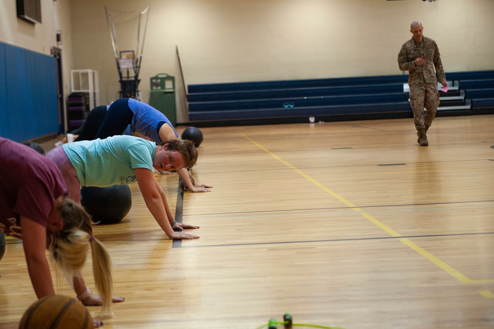 A photo of participants of Family Boot Camp performing mountain climbers