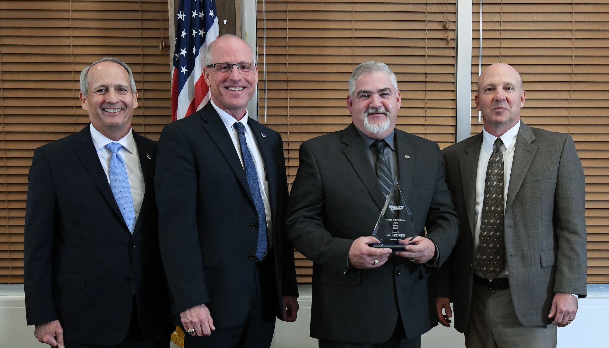 Machinist Chief Craftsperson Jim Hereford, thid from left, receives the Safety Award during the National Aerospace Solutions, LLC, Salute to Excellence Annual Awards Banquet, Nov. 5, 2019, at the Arnold Lakeside Center, Arnold Air Force Base, Tennessee. Also pictured, from left, is NAS Deputy General Manager Michael Belzil, NAS General Manager Dr. Richard Tighe and NAS Performance Assurance Director Mark Bymaster. (U.S. Air Force photo by Jill Pickett)
