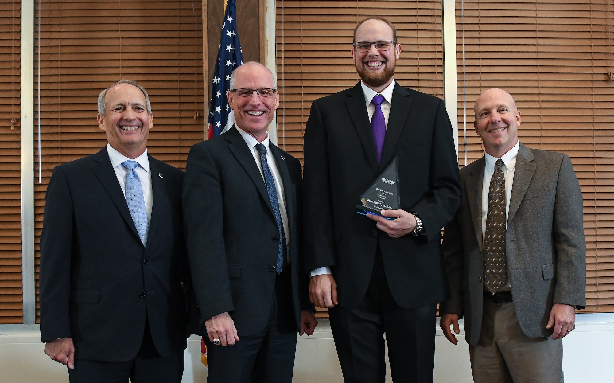 Test Operations Engineer II Benjamin Howell, third from the left, receives the Security Award during the National Aerospace Solutions (NAS), LLC, Salute to Excellence Annual Awards Banquet, Nov. 5, 2019, at the Arnold Lakeside Center, Arnold Air Force Base, Tenn. Also pictured, from left, is NAS Deputy General Manager Michael Belzil, NAS General Manager Dr. Richard Tighe and NAS Performance Assurance Director Mark Bymaster. (U.S. Air Force photo by Jill Pickett)