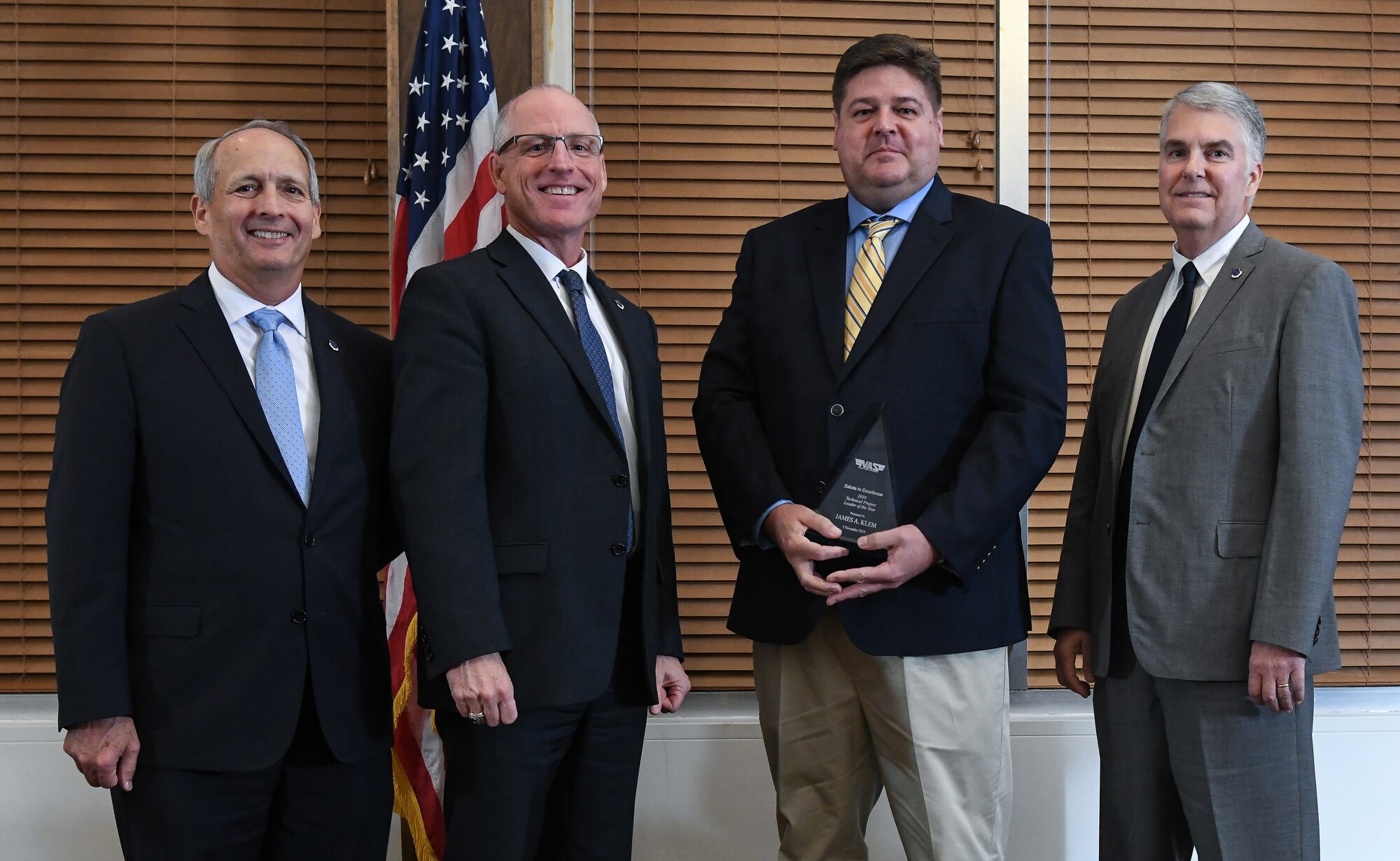 Capital Project Manager James Klem, third from left, receives the Technical Project Leader of the Year award during the National Aerospace Solutions (NAS), LLC, Salute to Excellence Annual Awards Banquet, Nov. 5, 2019, at the Arnold Lakeside Center, Arnold Air Force Base, Tenn. Also pictured, from left, is NAS Deputy General Manager Michael Belzil, NAS General Manager Dr. Richard Tighe and NAS Mission Execution Director Jeff Henderson. (U.S. Air Force photo by Jill Pickett)