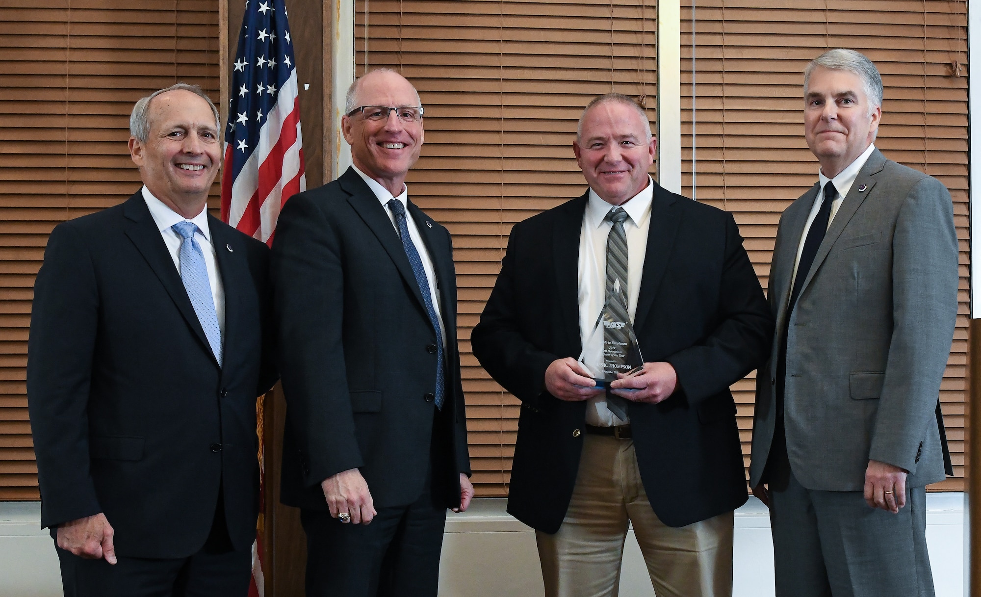 Test Operations Engineer III Kevin Thompson, third from left, receives the Test Operations Engineer of the Year award during the National Aerospace Solutions(NAS), LLC, Salute to Excellence Annual Awards Banquet, Nov. 5, 2019, at the Arnold Lakeside Center, Arnold Air Force Base, Tenn. Also pictured, from left, is NAS Deputy General Manager Michael Belzil, NAS General Manager Dr. Richard Tighe and NAS Mission Execution Director Jeff Henderson. (U.S. Air Force photo by Jill Pickett)