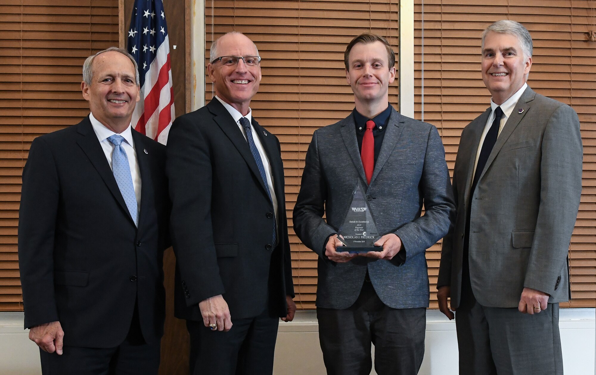 Mechanical/Aeronautical Engineer III Nicholas Fredrick, third from left, receives the Engineer of the Year award during the National Aerospace Solutions (NAS), LLC, Salute to Excellence Annual Awards Banquet, Nov. 5, 2019, at the Arnold Lakeside Center, Arnold Air Force Base, Tenn. Also pictured, from left, is NAS Deputy General Manager Michael Belzil, NAS General Manager Dr. Richard Tighe and NAS Mission Execution Director Jeff Henderson. (U.S. Air Force photo by Jill Pickett)