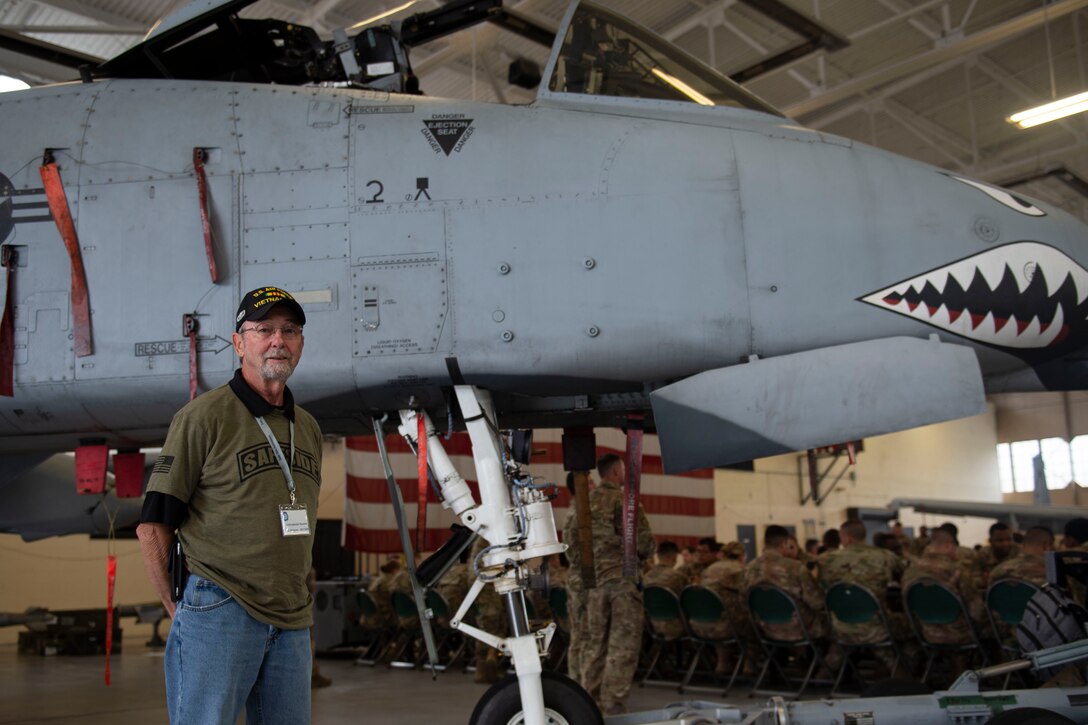 A photo of a Safeside Association member posing for a photo with an aircraft.