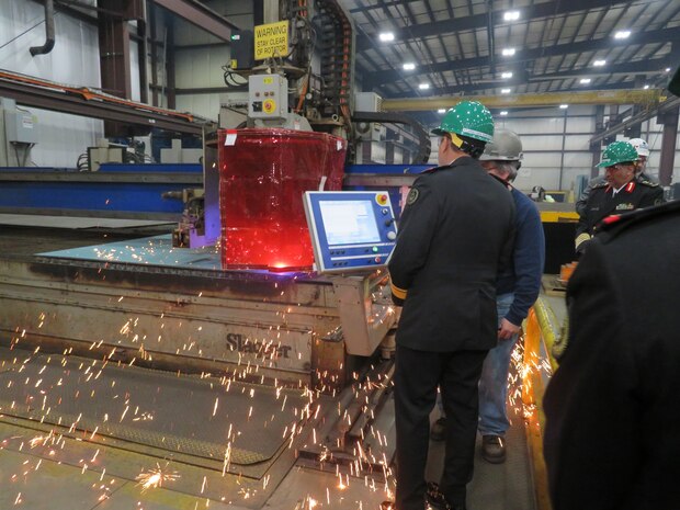 Royal Saudi Naval Forces Eastern Fleet Commander Admiral Fahad Al-Shimrami views MMSC steel cutting in progress at FMM as sparks fly.