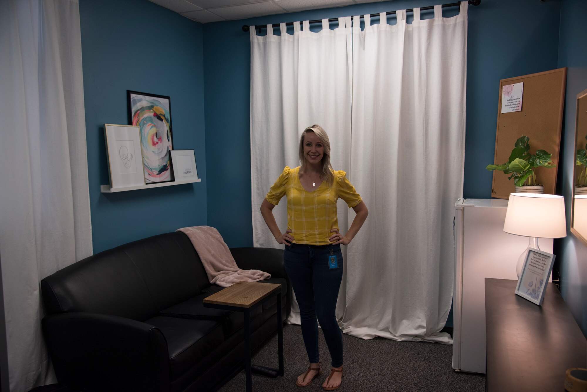 Kath Barber, wife of 726 Air Control Squadron commander, poses in the finished mothers' room, Sept. 09, 2019, Mountain Home Air Force Base, Idaho. The couch to Kath's right was donated by the Barber family for the ACS mothers use. (U.S. Air Force photo by Airman 1st Class Nicholas Swift)