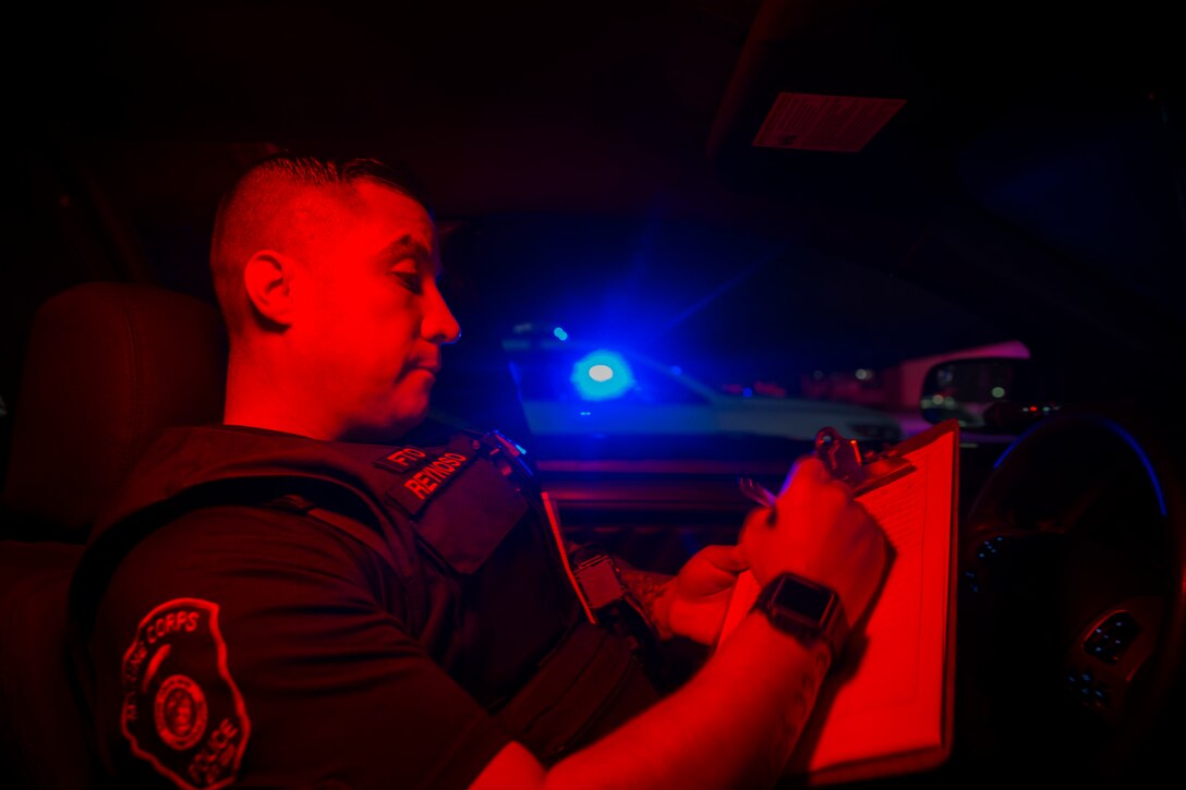 Officer Samuel Reynoso, with the Provost Marshal’s Office, Security and Emergency Services Battalion, Marine Corps Base Camp Pendleton, fills out a safety vehicle checklist prior to starting his shift at the SES Bn. building on Camp Pendleton, California, Aug. 22, 2019. Marines and civilian officers have been working together since 2005 on Camp Pendleton. The Marine Corps Law Enforcement Program was put into place so civilian police officers could protect the base while Marines were deployed. (U.S Marine Corps photo by Lance Cpl. Andrew Cortez)