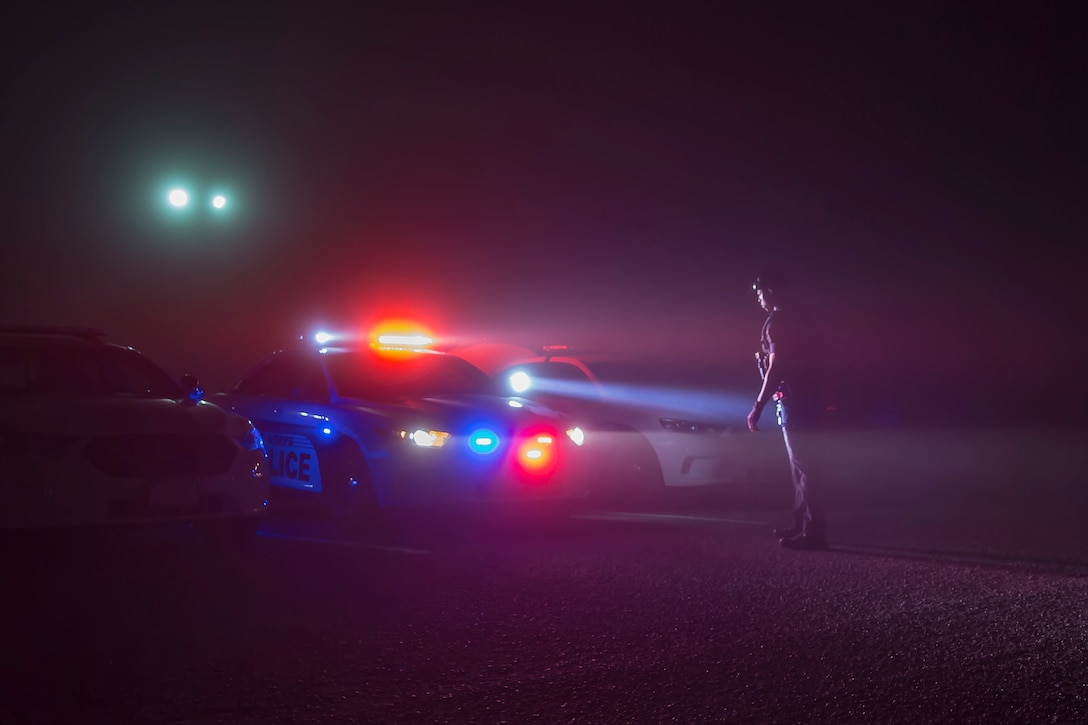 Officer Jonathan Gibbs, with the Provost Marshal’s Office, Security and Emergency Services Battalion, Marine Corps Base Camp Pendleton, checks the lights on a police car to ensure everything is working properly prior to starting his shift at the SES Bn. building on Camp Pendleton, California, Aug. 18, 2019. Every shift at PMO begins with guard mount. This routine starts with drawing gear, loading weapons, a morning brief and an accountability formation. (U.S Marine Corps photo by Lance Cpl. Andrew Cortez)