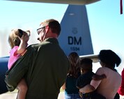 A U.S. Air Force member holds his daughter