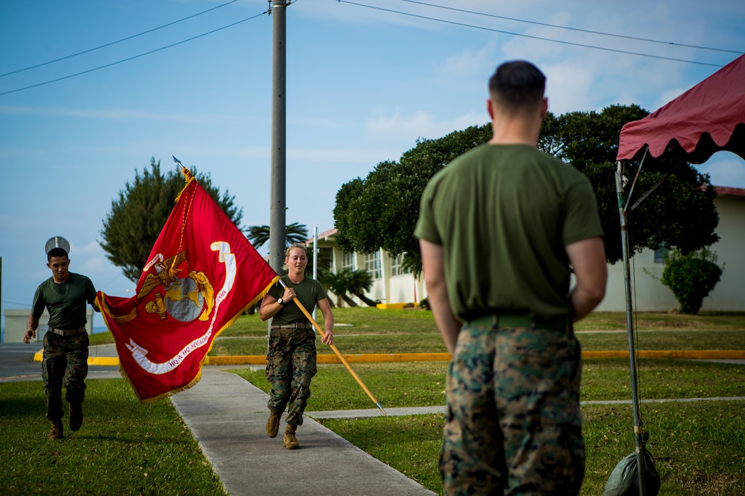 Marines with Headquarters and Headquarters Squadron, Marine Corps Air Station (MCAS) Futenma, carries the Marine Corps colors during a 24-hour motivational run celebrating the Marine Corps birthday, Nov. 7, 2019. During the run, Marines throughout the squadron reserved time to run with the Marine Corps colors to make up a collective 244 miles. (U.S. Marine Corps photo by Lance Cpl. Kindo Go)