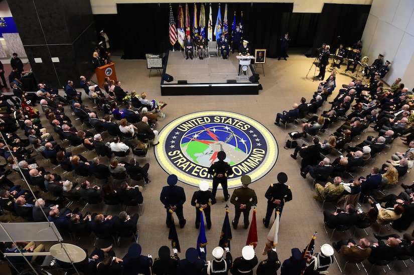 An audience, shown from overhead, attends a ceremony.