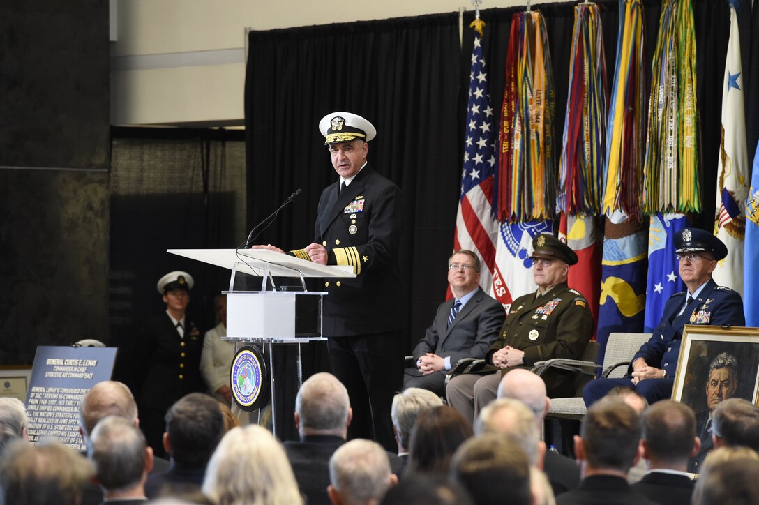 Navy Adm. Charles A. Richard speaks at a lectern in front of an audience.