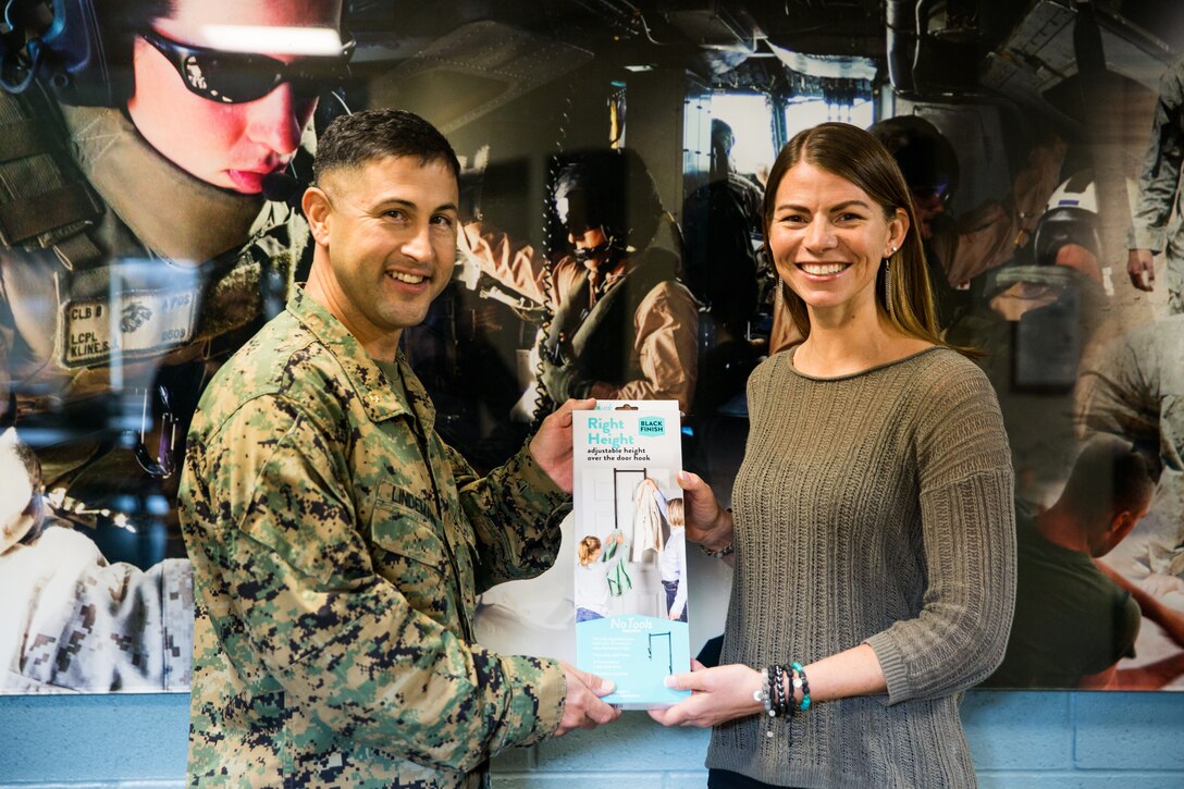 U.S. Marine Maj. Jimmy Lindemann, the operations officer with Wounded Warrior Battalion - West, poses with April Mitchell, the creator of the Right Height door hook, at the battalion headquarters on Marine Corps Base Camp Pendleton, California, Nov. 15, 2019. Mitchell, a military spouse, created Right Height in hopes of giving individuals with less mobility more independence. Lindemann is a native of Needville, Texas, and Mitchell is a native of Lake Mills, Wisconsin. (U.S. Marine Corps photo by Lance Cpl. Alison Dostie)