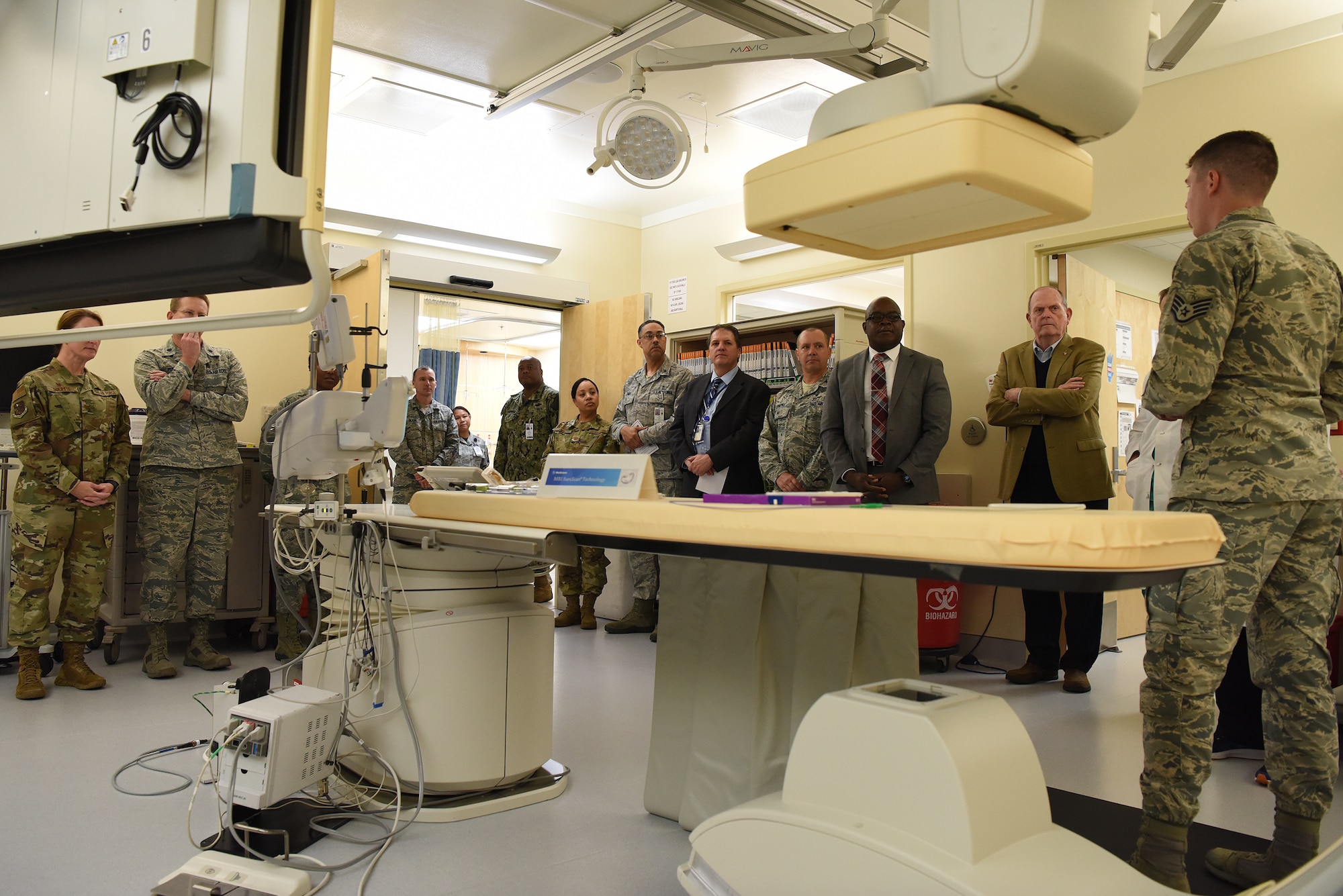 U.S. Air Force Staff Sgt. Matthew Slaven, 81st Medical Operations Squadron cardiopulmonary technician, briefs 81st Medical Group staff and guests on cath lab capabilities during the cardiac catheterization laboratory ribbon cutting ceremony inside Keesler Medical Center at Keesler Air Force Base, Mississippi, Nov. 15, 2019. The lab was upgraded with an entire suite of technology to provide better and safer care for patients and the surgical team. (U.S. Air Force photo by Senior Airman Suzie Plotnikov)