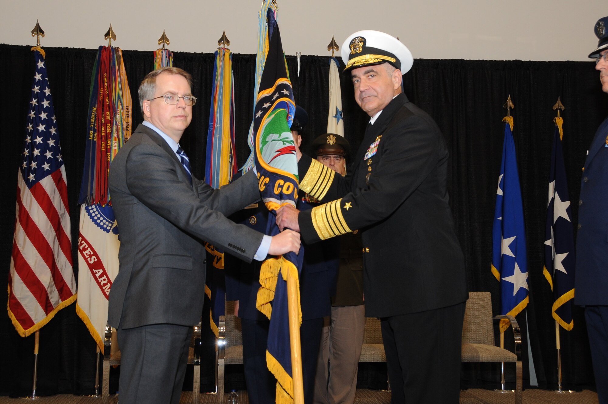 U.S. Navy Adm. Charles A. Richard accepts the U.S. Strategic Command guidon from Deputy Secretary of Defense David L. Norquist as he assumes command of U.S. Strategic Command (USSTRATCOM) during a change of command ceremony at Offutt Air Force Base, Neb., Nov. 18, 2019. Richard comes to USSTRATCOM after serving as the commander of Submarine Forces; commander of Submarine Force Atlantic and commander of Allied Submarine Command at Naval Station Norfolk, Va. USSTRATCOM has global responsibilities assigned through the Unified Command Plan that include strategic deterrence, nuclear operations, joint electromagnetic spectrum operations, global strike, missile defense, and analysis and targeting. (U.S. Air Force photo by Steve Cunningham)