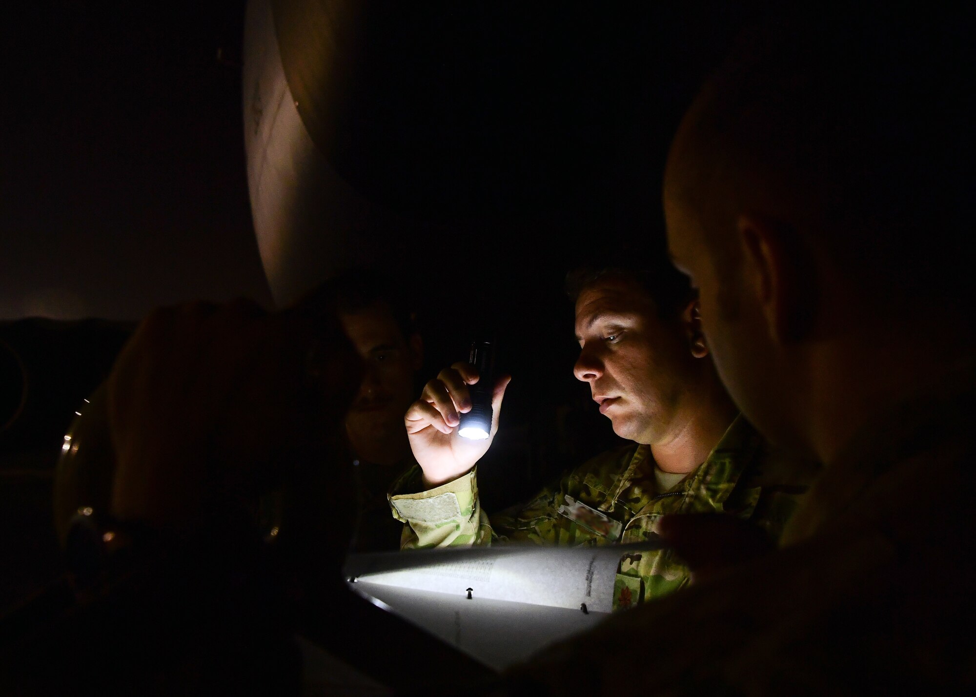 A U.S. Air Force pilot assigned to the 28th Expeditionary Air Refueling Squadron, conducts preflight brief outside of a KC-135 Stratotanker at Al Udeid Air Base, Qatar, Sept. 28, 2019.