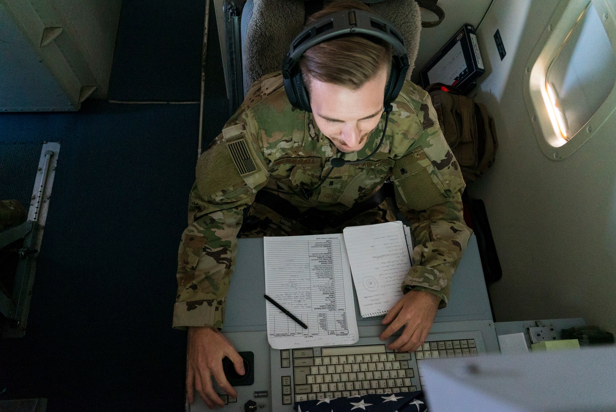 A U.S. Airman assigned to the 7th Expeditionary Airborne Command and Control Squadron, conducts operations in an E-8 Joint STARS above an undisclosed location, Sept. 28, 2019.