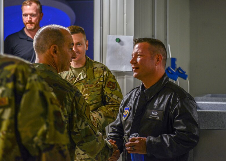 U.S. Air Force Gen. Jeffrey L. Harrigian, U.S. Air Forces in Europe and Air Forces Africa commander, coins U.S. Air Force Capt. Justin Hannaford, 31st Fighter Wing aerospace physiologist, at Aviano Air Base, Italy, Nov. 15, 2019. Challenge coins are a form of recognition of the hard work and excellence an individual has displayed. (U.S. Air Force photo by Airman Thomas S. Keisler IV)