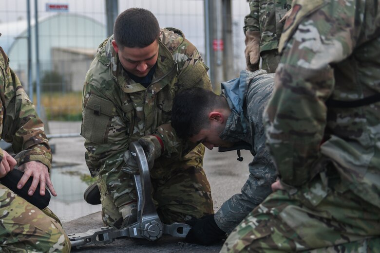 U.S. Airmen from the 31st Maintenance Squadron prepare a lifting sling at Aviano Air Base, Italy, Nov. 16, 2019. The 31st MXS provides accessory maintenance, avionics, periodic phase inspections, fabrication, and aerospace ground equipment for 50 assigned aircrafts. (U.S. Air Force photo by Airman 1st Class Ericka A. Woolever).