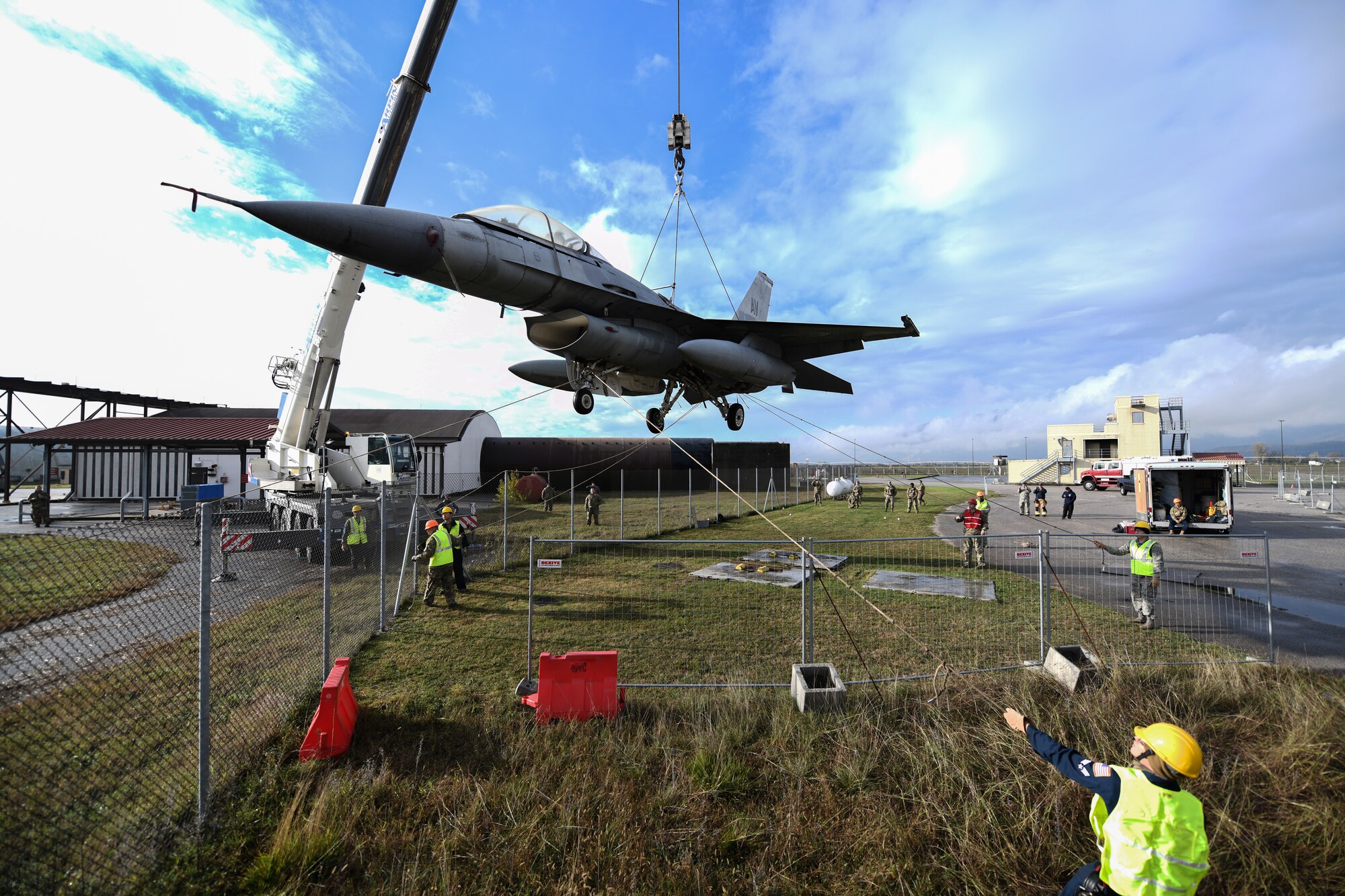 U.S. Airmen from the 31st Maintenance Squadron rotate an F-16 Fighting Falcon as it lifts from the ground at Aviano Air Base, Italy, Nov. 16, 2019. The purpose of a real-world crashed damaged disabled aircraft recovery is to clear the runway as safely and quickly as possible while causing no further damage to the aircraft. (U.S. Air Force photo by Airman 1st Class Ericka A. Woolever).