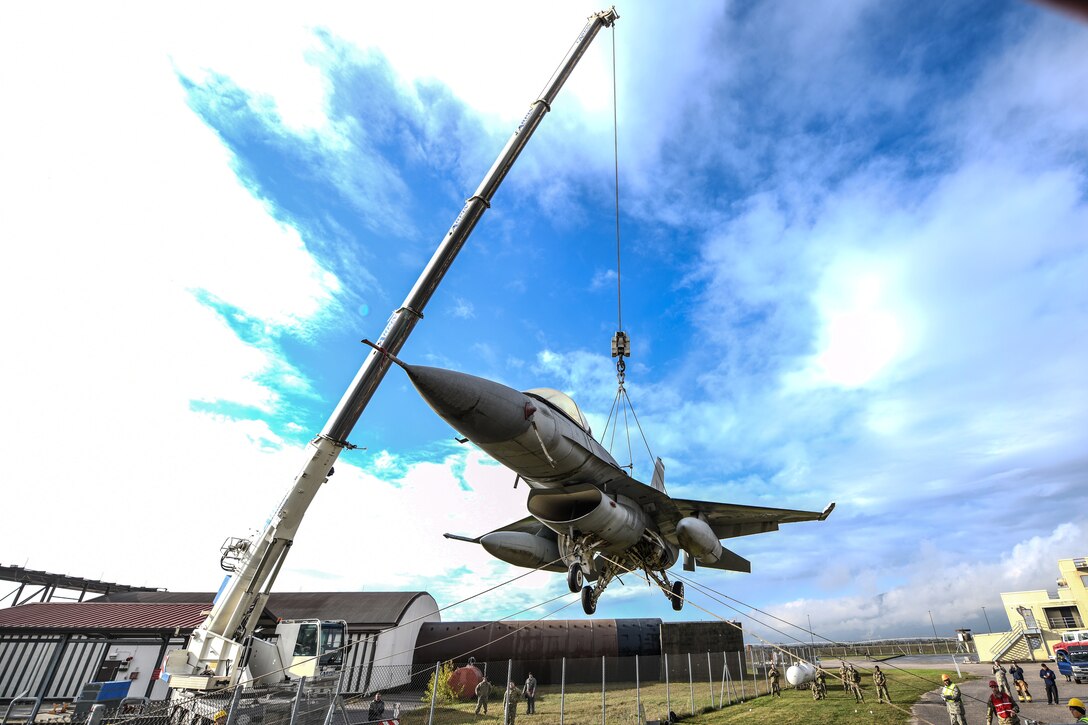 U.S. Airmen from the 31st Maintenance Squadron rotate an F-16 Fighting Falcon as it lifts from the ground at Aviano Air Base, Italy, Nov. 16, 2019. The purpose of a real-world crashed damaged disabled aircraft recovery is to clear the runway as safely and quickly as possible while causing no further damage to the aircraft. (U.S. Air Force photo by Airman 1st Class Ericka A. Woolever).