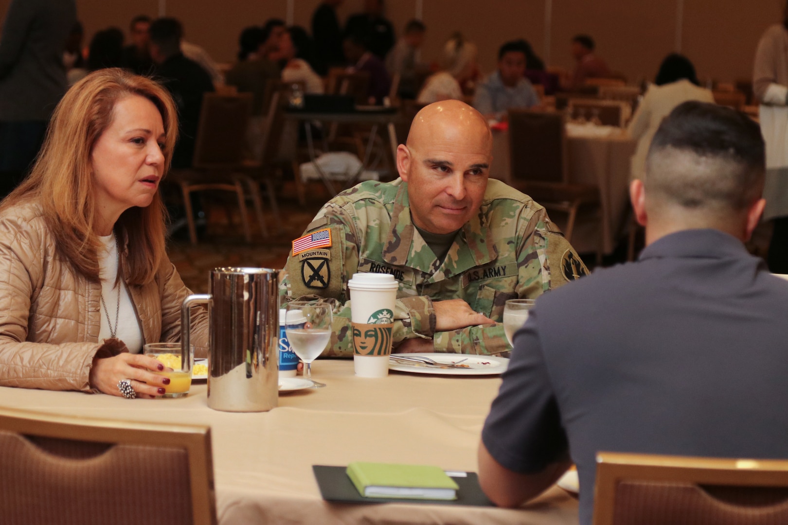 Maj. Gen. Alberto Rosende, commanding general of the 63rd Readiness Division, and his wife, Martha, talk to an Army Reserve Soldier and his spouse at a Yellow Ribbon event in Anaheim, California, Nov. 16, 2019.