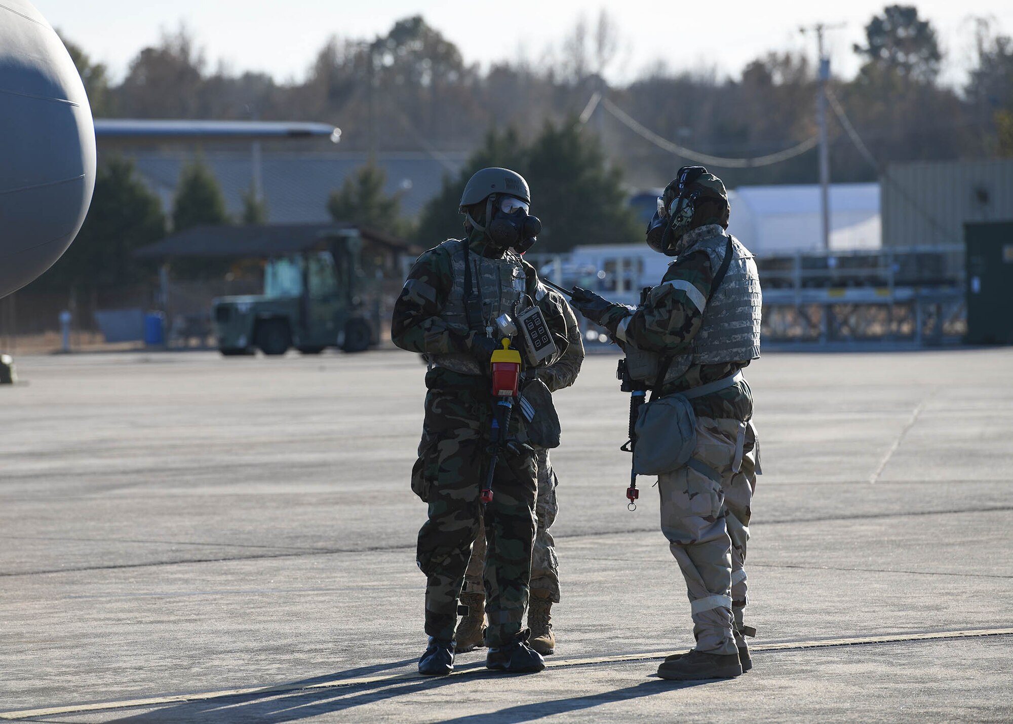 An airman uses a tool to scan for radiation