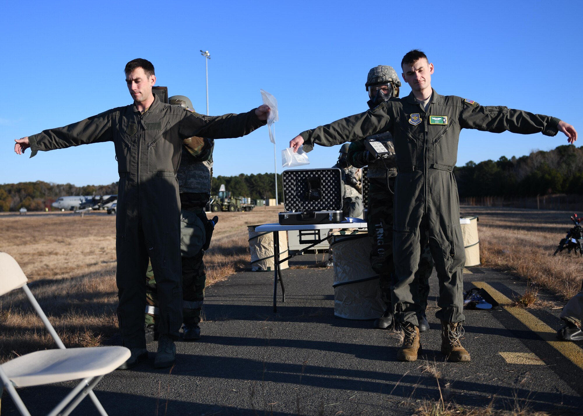 An airman uses a tool to scan for radiation