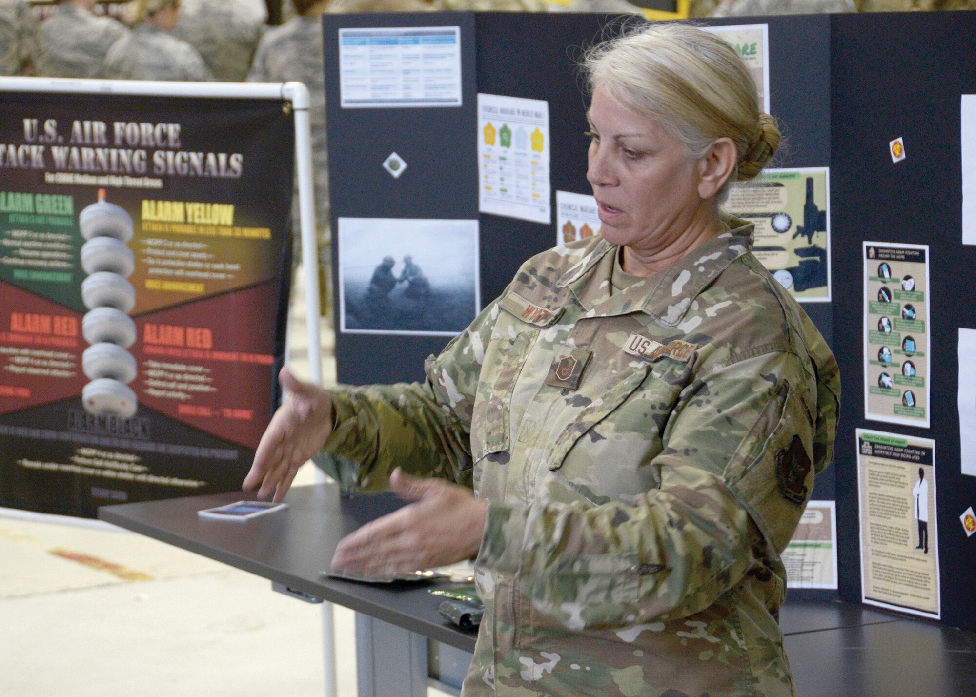 Master Sgt. Kathleen Wyatt, a chemical, biological, radiological and nuclear (CBRN) trainer with the 445th Civil Engineering Squadron emergency management staff, assists in mass CBRN training on Oct. 6, 2019, at Wright Patterson Air Force Base, Ohio. CBRN training equips airmen with the skills needed to operate in an environment that has been corrupted by chemical, biological, radiological or nuclear contaminants.
