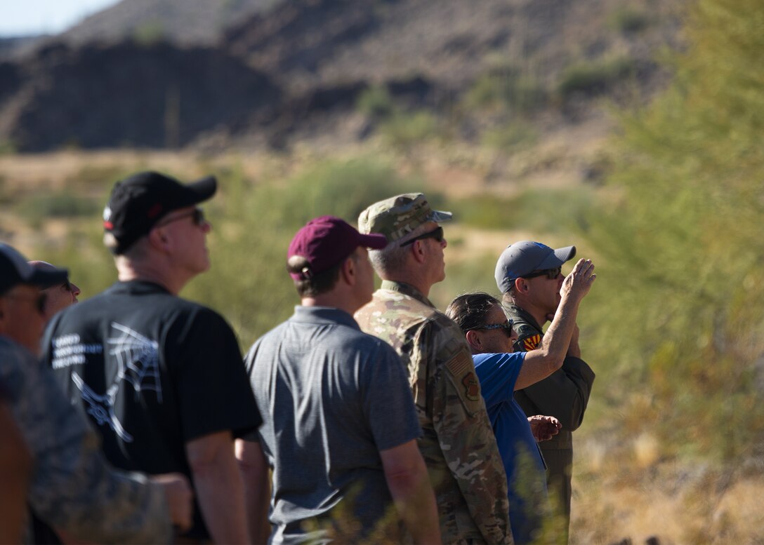 Adrianne Rankin (second from right), 56th Range Management Office archaeologist, briefs Luke Air Force Base commanders and honorary commanders on Native American petroglyphs Nov. 14, 2019, at the Chris Glyphs Archeological Site, Ariz.