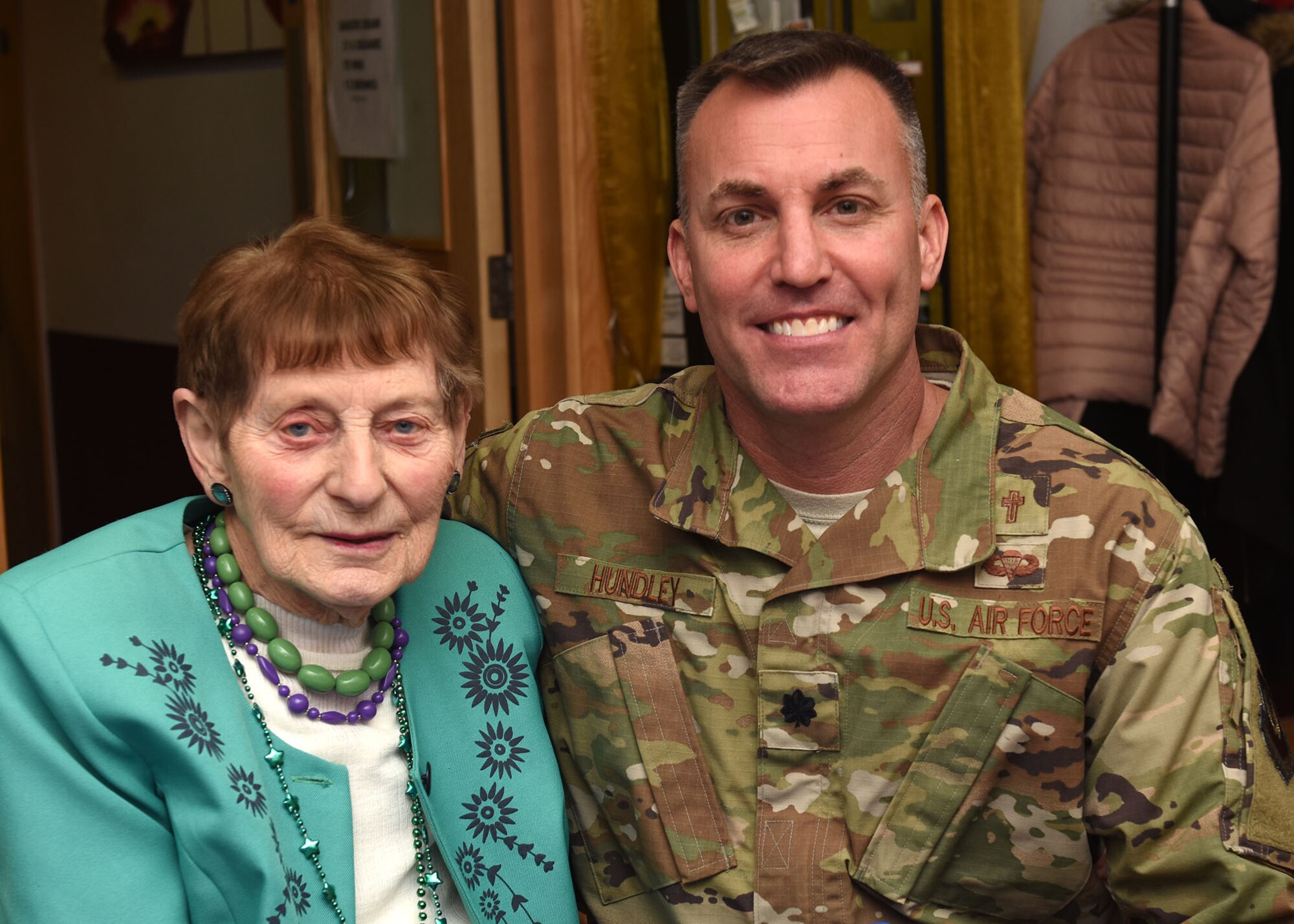 U.S. Air Force Chaplain (Lt. Col) Kyle Hundley, 100th Air Refueling Wing chaplain, poses for a photo with Iris Weimer, a guest at a Thanksgiving lunch at the Mildenhall Social Club, Mildenhall, England, Nov. 18, 2019. Base leadership, Airmen and BAC members from RAF Mildenhall served the luncheon to build relations and give back to the local community. (U.S. Air Force photo by Karen Abeyasekere)