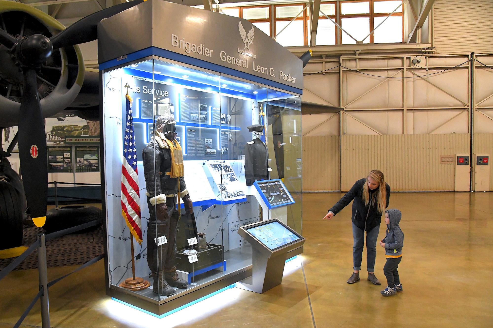 Guests Shaylin Shaulval and Thomas Gearing look at a new military heroes exhibit at the Hill Aerospace Museum, Oct. 26, 2019, at Hill Air Force Base, Utah. Brig. Gen. Leon C. Packer was first inductee into the exhibit series that is intended to preserve the rich heritage of Utah’s Airmen heroes and the contributions they made in the nation’s defense. The general served as a bomber pilot in World War II. (U.S. Air Force photo by Todd Cromar)