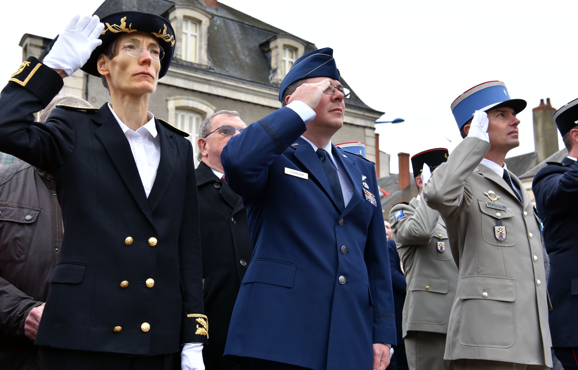 U.S. Air Force Maj. John Cockburn (center), 32nd Aerial Refueling Squadron operations officer, salutes during the French national anthem, along with members of the French government, during an Armistice Day commemoration Nov. 11, 2019, in Issoudun, France.  Airmen from the 32nd ARS at Joint Base McGuire-Dix-Lakehurst, New Jersey, attended the ceremony to help commemorate the day and honor fallen Airmen who were stationed at the 3rd Aviation Instruction Center during World War I. (U.S. Air Force photo by Tech. Sgt. Chris Powell)