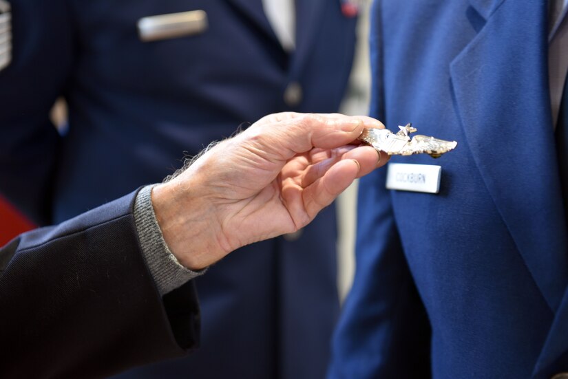 A French military veteran holds an aviation badge given to him by U.S. Air Force Maj. John Cockburn, 32nd Aerial Refueling Squadron operations officer, after an Armistice Day commemoration Nov. 11, 2019, in Issoudun, France. Airmen from the 32nd ARS at Joint Base McGuire-Dix-Lakehurst, New Jersey, attended the ceremony to help commemorate the day and honor fallen Airmen who were stationed at the 3rd Aviation Instruction Center during World War I. (U.S. Air Force photo by Tech. Sgt. Chris Powell)