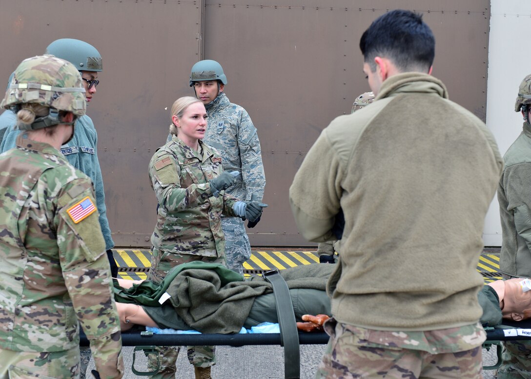 U.S. Air Force Staff Sgt. Bianca Marts, 86th Aerospace Medicine Squadron NCO in charge of Enroute Patient Staging mission management, provides instruction to Airmen and Soldiers for coordinating litter movements and loading litters onto a truck at Ramstein Air Base, Germany Nov. 15, 2019. Movements while carrying a litter should be carefully coordinated to ensure no further injury is caused during patient transport. (U.S. Air Force photo by Staff Sgt. Jimmie D. Pike)