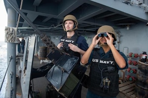 Master-At-Arms Seaman Khang Ho, right, and Seaman Shane Mitchell search for surface contacts during a Strait of Hormuz transit aboard the guided-missile cruiser USS Leyte Gulf (CG 55). Leyte Gulf is deployed to the U.S. 5th Fleet area of operations in support of naval operations to ensure maritime stability and security in the Central Region, connecting the Mediterranean and Pacific through the Western Indian Ocean and three strategic choke points.