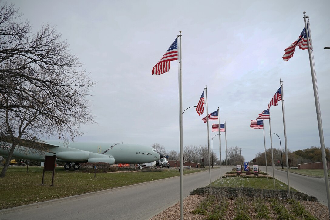 United States flags fly in place of the usual state flags leading up to the installation front gate Nov. 8, 2019, on Grand Forks Air Force Base, North Dakota. The flags that fly over the installation entryway usually represent the 50 states, but were changed to U.S. flags in honor of Veterans Day. (U.S. Air Force photo by Senior Airman Elora J. Martinez)