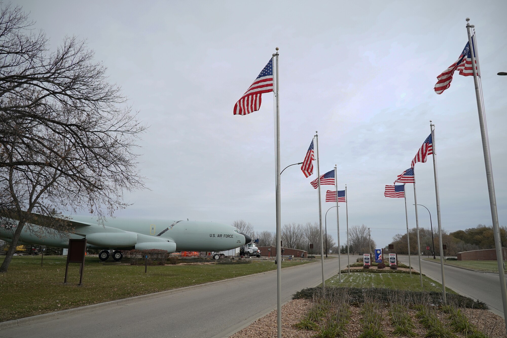 United States flags fly in place of the usual state flags leading up to the installation front gate Nov. 8, 2019, on Grand Forks Air Force Base, North Dakota. The flags that fly over the installation entryway usually represent the 50 states, but were changed to U.S. flags in honor of Veterans Day. (U.S. Air Force photo by Senior Airman Elora J. Martinez)