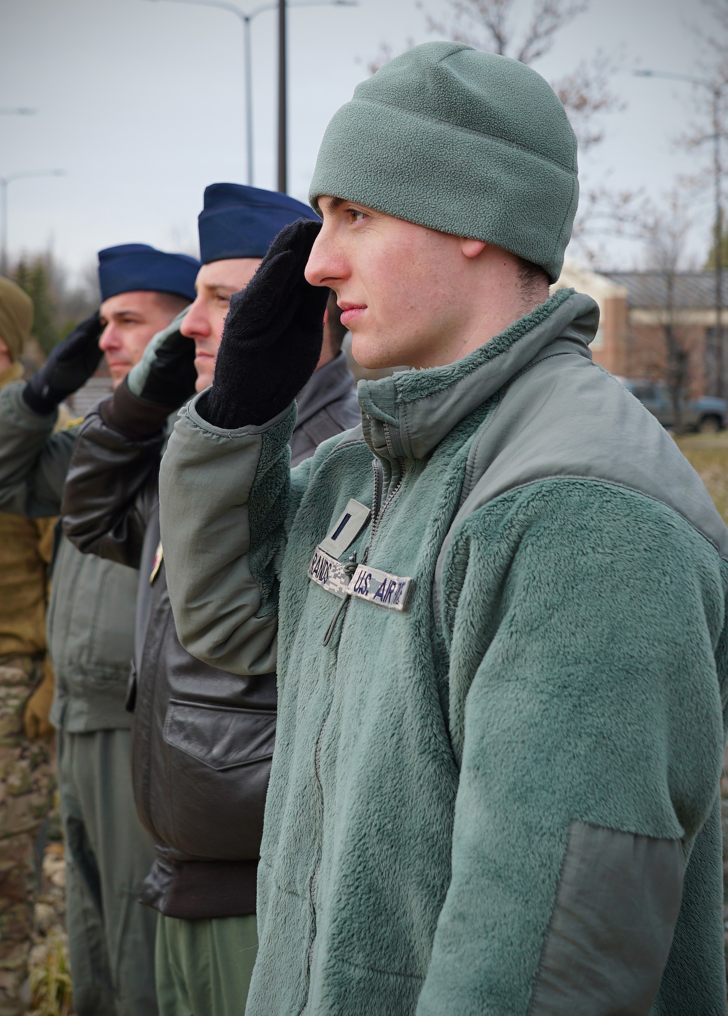 First Lt. Nathan Rands, 348th Reconnaissance Squadron chief of intelligence operations and analysis, salutes a United States flag as it is raised Nov. 8, 2019, on Grand Forks Air Force Base, North Dakota. In honor of Veterans Day, 348 RS members replaced the installation’s avenue of state flags with U.S. flags, serving as a thank you for all servicemembers, past and present. (U.S. Air Force photo by Senior Airman Elora J. Martinez)