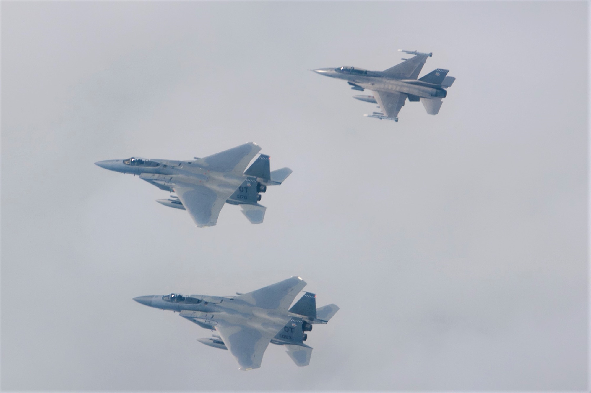 U.S. Air Force F-15C Pilots, Capt. Aaron Eshkenazi and Maj. Jonah Brown, and F-16 Pilot, Lt. Col. Matthew Russell, from the 85th Test and Evaluation Squadron, Eglin AFB, Fla. prepare to flyover the Miami Dolphins' stadium on November 17, 2019.