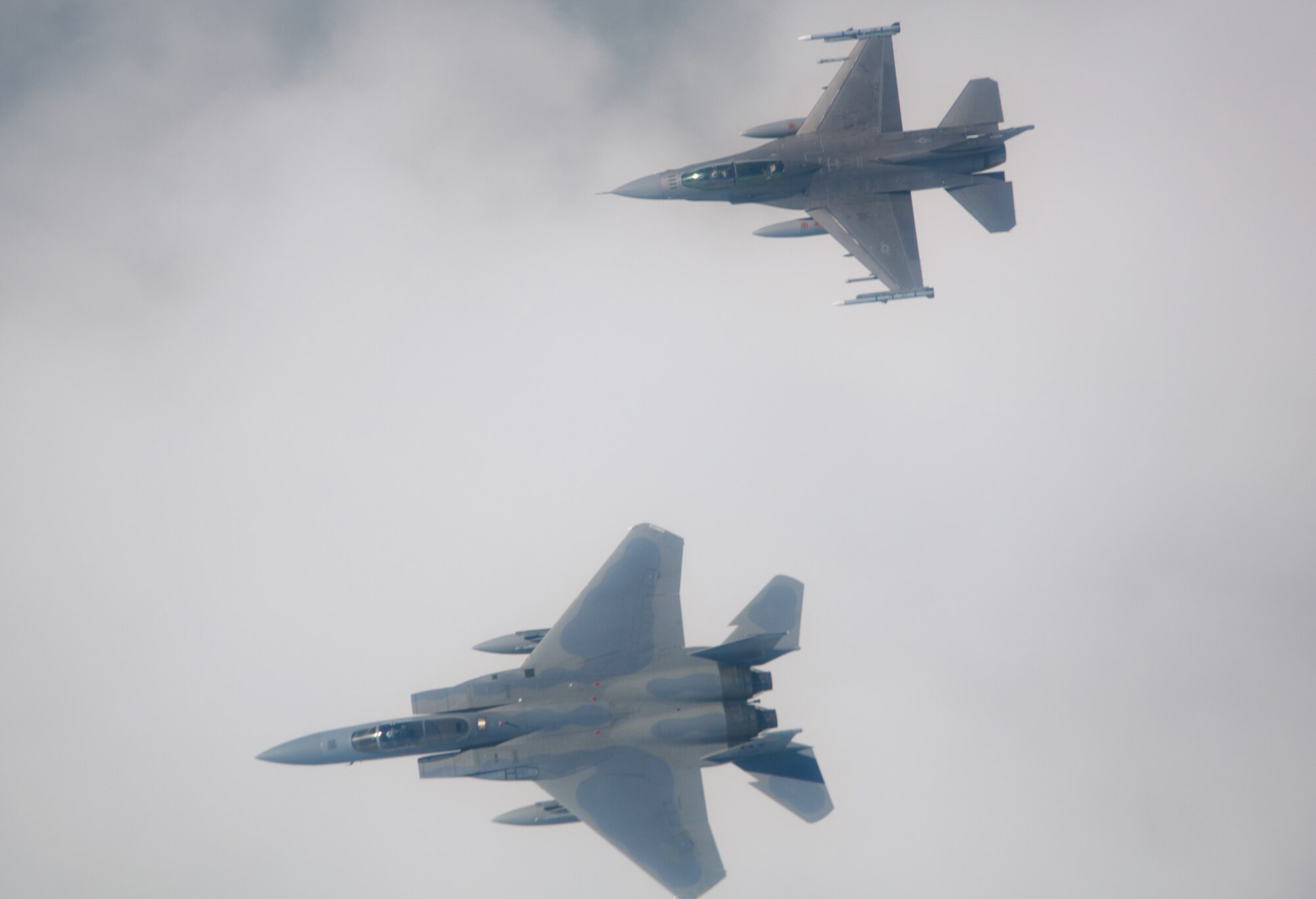U.S. Air Force F-15C Pilot Maj. Jonah Brown and F-16 Pilot, Lt. Col. Matthew Russell from the 85th Test and Evaluation Squadron, Eglin AFB, Fla. prepare to flyover the Miami Dolphins' stadium on November 17, 2019.