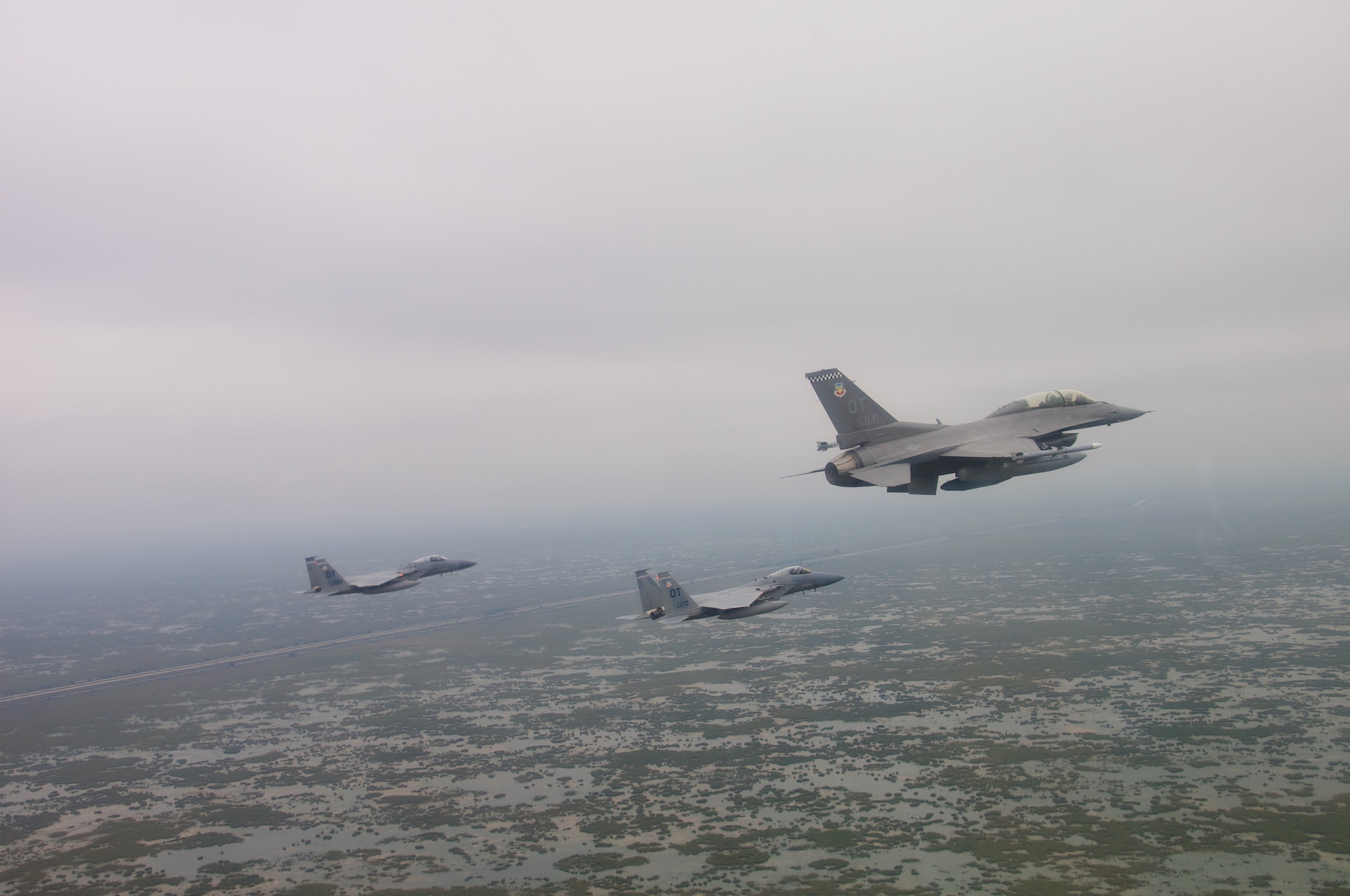 U.S. Air Force F-15C Pilots, Capt. Aaron Eshkenazi and Maj. Jonah Brown, and F-16 Pilot, Lt. Col. Matthew Russell, from the 85th Test and Evaluation Squadron, Eglin AFB, Fla. prepare to flyover the Miami Dolphins' stadium on November 17, 2019.