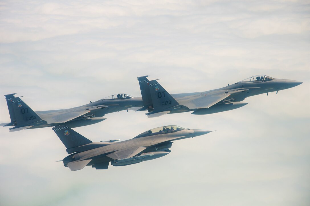 U.S. Air Force F-15C Pilots, Capt. Aaron Eshkenazi and Maj. Jonah Brown, and F-16 Pilot, Lt. Col. Matthew Russell, from the 85th Test and Evaluation Squadron, Eglin AFB, Fla. prepare to fly over the Miami Dolphins' stadium on November 17, 2019.