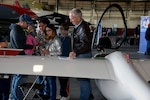 The Adame family considers gliding with the San Antonio Soaring Society Inc. during the Youth Aerospace Expo at Kelly Field, Texas, Nov. 16, 2019.