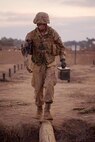 A recruit with Delta Company, 1st Recruit Training Battalion, runs across a log during the crucible at Marine Corps Base Camp Pendleton, California, Nov. 6, 2019.