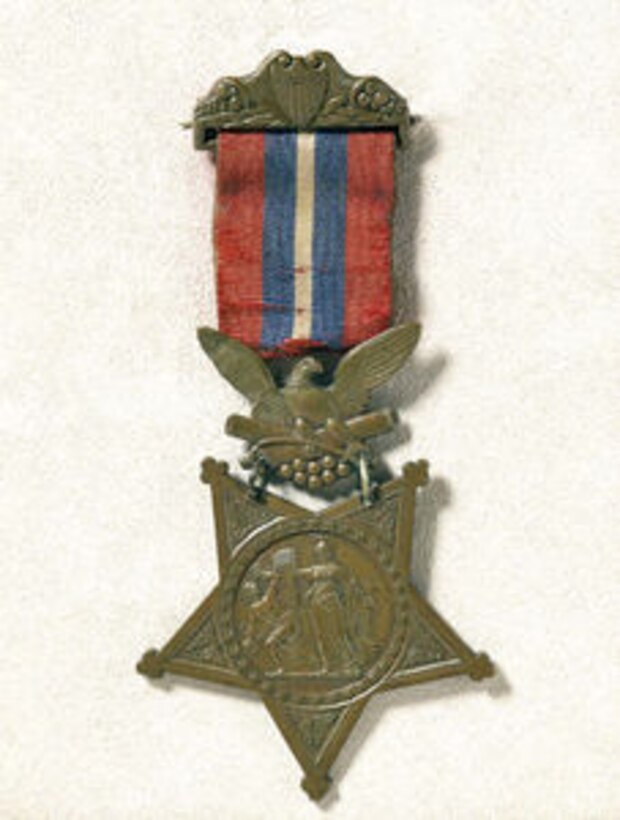 A Civil War-era Medal of Honor with red, white and blue ribbon.