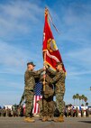U.S. Marine Corps Col. Jay M. Holtermann, right, the 15th Marine Expeditionary Unit outgoing commanding officer, passes the colors to Col. Christopher J. Bronzi, incoming commanding officer, during a change of command ceremony at Marine Corps Base Camp Pendleton, California, Nov. 13, 2019.