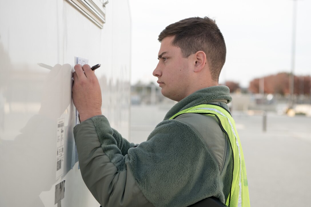 Airman 1st Class Timothy Mazurek, 436th Aerial Port Squadron special cargo processor, reviews information on a shipping form during the Dover Operational Readiness for a Multi-domain Agile Response Exercise Nov. 14, 2019, at Dover Air Force Base, Del. The exercise featured a simulated mass troop deployment, base power outage and active shooter drill. (U.S. Air Force photo by Mauricio Campino)