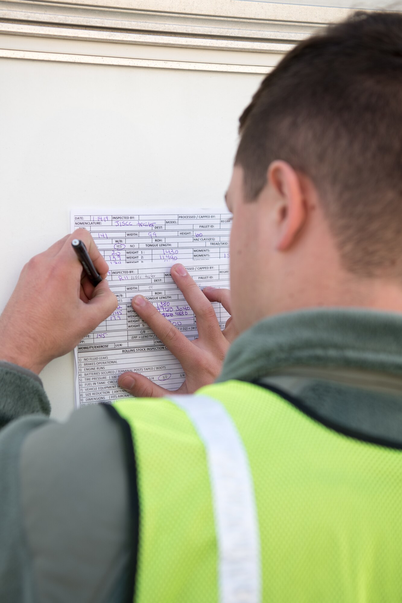 Airman 1st Class Timothy Mazurek, 436th Aerial Port Squadron special cargo processor, reviews information on a shipping form during the Dover Operational Readiness for a Multi-domain Agile Response Exercise Nov. 14, 2019, at Dover Air Force Base, Del. Shipping forms for vehicles must be checked to ensure they list the proper weight and destination. (U.S. Air Force photo by Mauricio Campino)