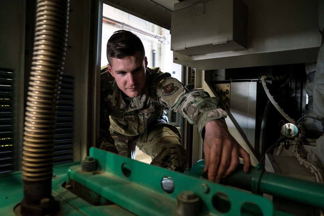 Senior Airman Justin Harrison, 90th Missile Maintenance Squadron, Facility Maintenance Section, support section supervisor, performs maintenance on a portable air condition unit on F.E. Warren AFB, Wyoming, Nov. 18, 2019. Tech. Sgt. Haisen Exon, 90 MMXS/FMS, support section NCOIC, teams up with the 90th Missile Wing LaunchWerx agency to bring forward an idea to prevent future head injuries across the wing. (U.S. Air Force photo by Joseph Coslett)